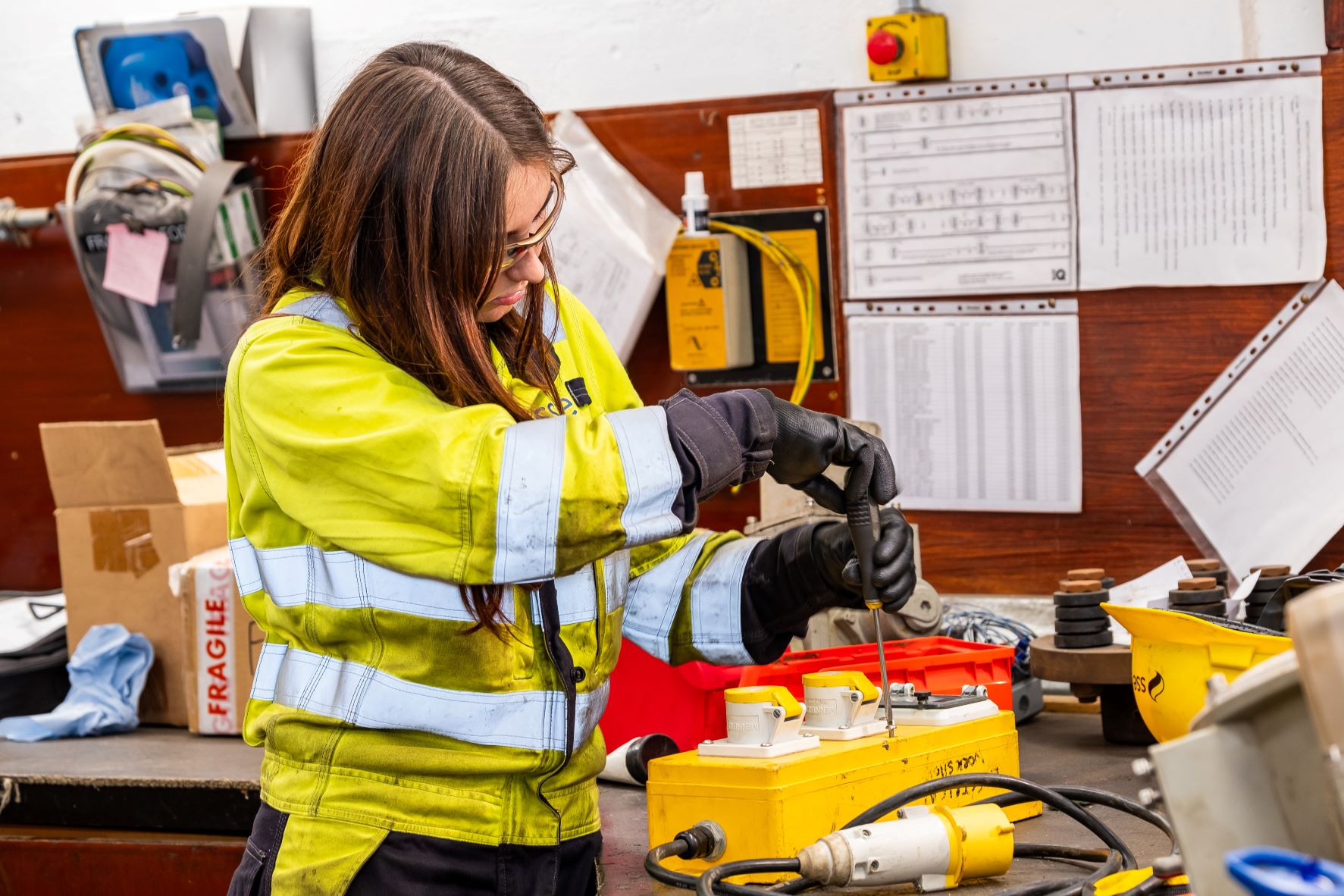 Woman in PPE with electrical equipment