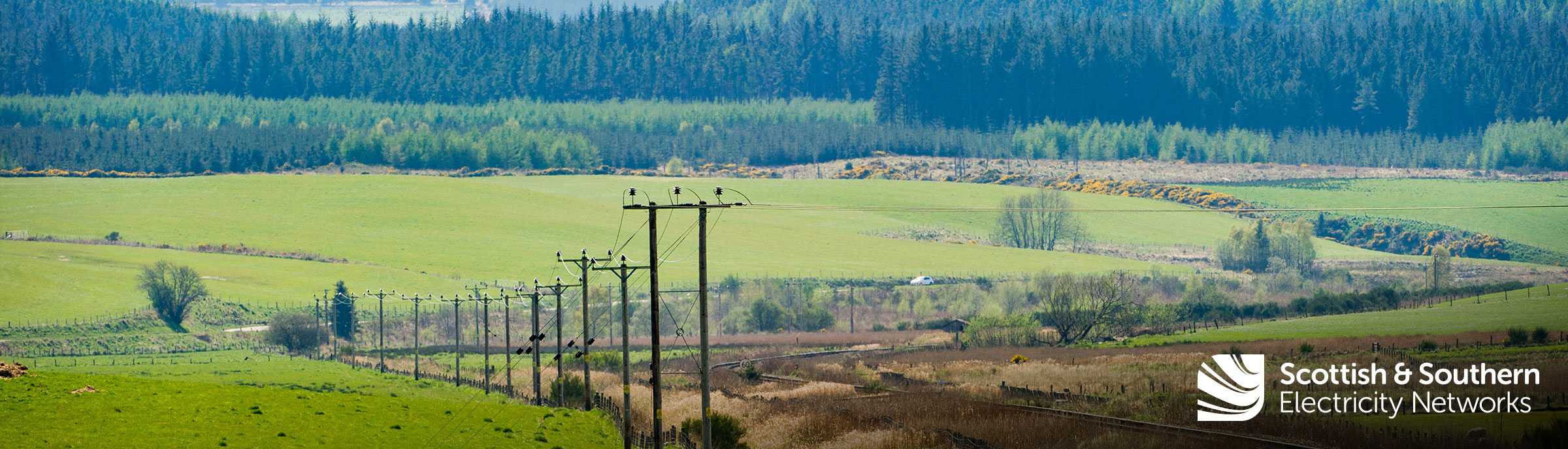 wind turbines past the hills in the distance