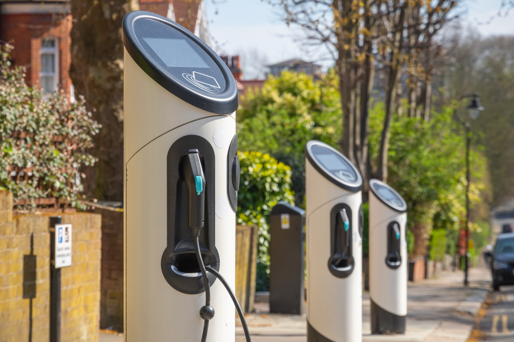 EV chargers in a tree-lined street