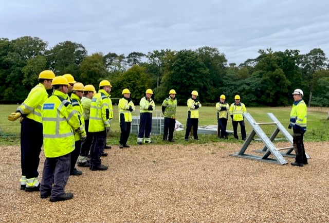 Engineers in high vis with flood barriers