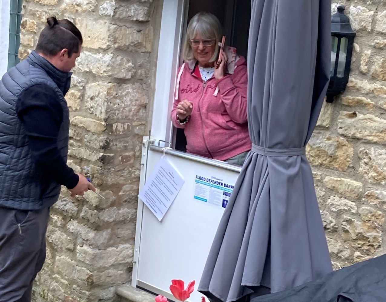 Woman and man standing at home flood barrier