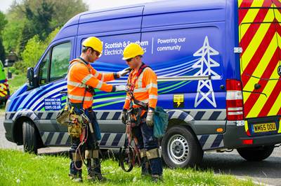 Two engineers in PPE standing outside next to SSEN van