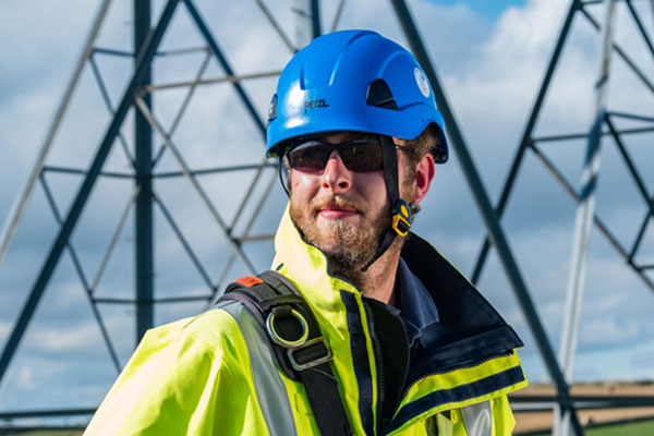 ssen linesmen in front of tower