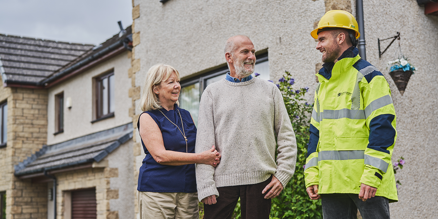 Image of engineer with customers at property 