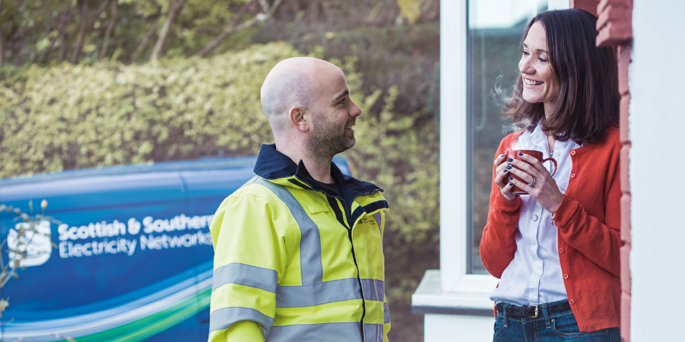 Engineer chatting with woman in doorway